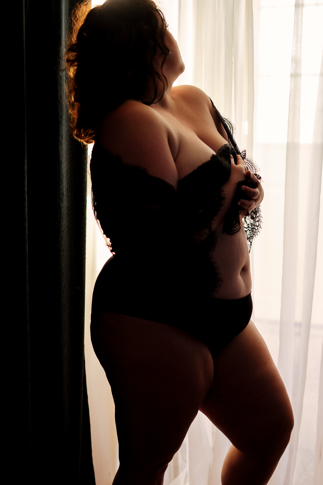 sexy curvy woman in lingerie during her boudoir shoot